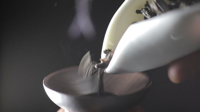 Measuring out the amount of tea leaves. Brewing tea in a teapot. Chinese traditional tea ceremony.