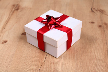 New Year gift on a golden tinsel background boly