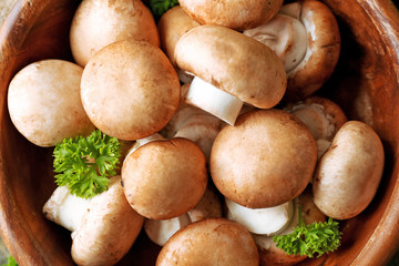 Mushrooms in wooden bowl, close-up