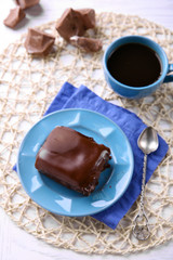 Delicious chocolate brownie on plate on wooden background