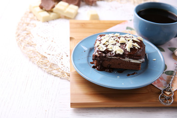 Delicious chocolate brownie on plate on wooden background