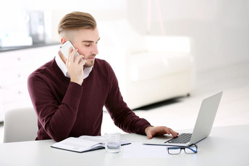 Businessman working with laptop in office