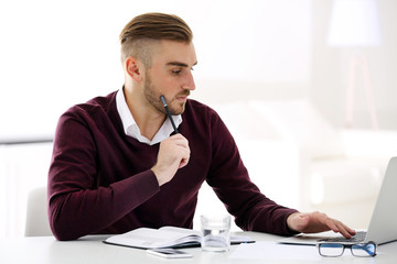 Businessman working with laptop in office
