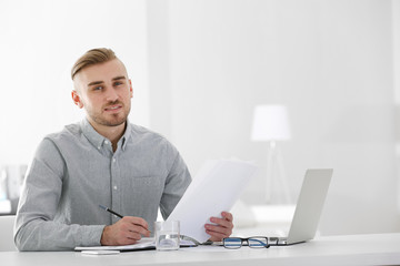Businessman working with laptop in office