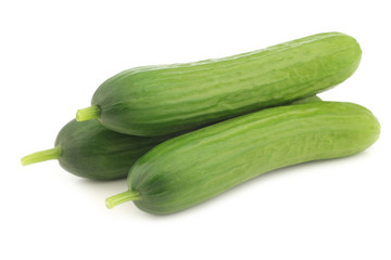 fresh green snack cucumbers on a white background