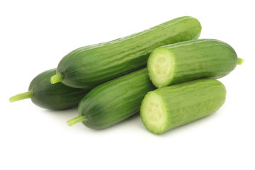 fresh green snack cucumbers on a white background