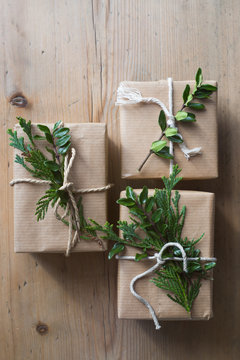 Simple gift wrapping idea: kraft paper, evergreen plants and twine. Selective focus
