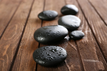 Obraz na płótnie Canvas Spa stones on wooden background