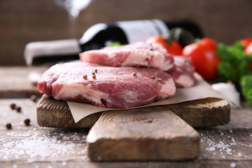 Marbled beef steak and spices on wooden background