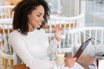 Young woman using tablet and headphones. 