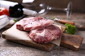 Marbled beef steak and spices on wooden background