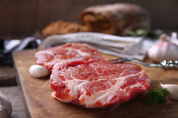 Marbled beef steak and spices on wooden background