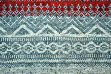 Red knitted background with Christmas patterns - sweater texture