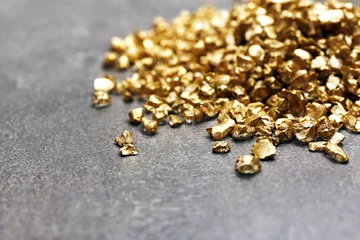 Deurstickers Metaal A pile of Gold nugget grains, on cement background