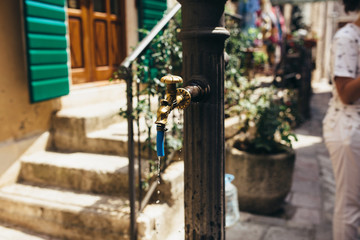 Fototapeta na wymiar Old drinking water pump in the old town of Kotor, Montenegro.