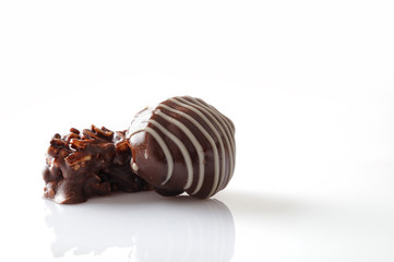 Two bonbons on a white table Front view Close up