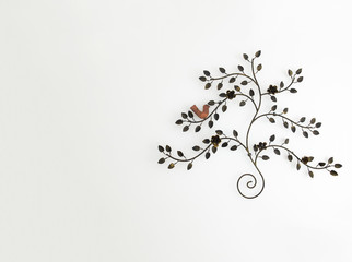 Vintage Style Tree made from Steel in Gold Color with Rose and Bird at the Corner on White Wall Background with Copyspace used as Template
