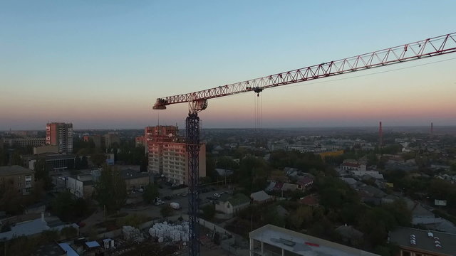 Tower crane at sunset. Departure quadrocopters. Aerial photography