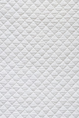 Closeup of white quilted fabric