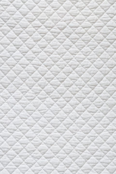 Closeup of white quilted fabric