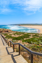 Fototapeta na wymiar Wooden walkway to Praia do Bordeira beach and beautiful blue sea view, Algarve region, Portugal