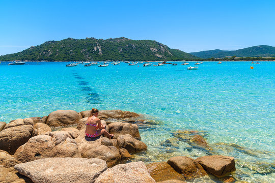 Unidentified young woman relaxing on Santa Giulia beach, Corsica island, France