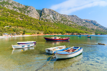 Fototapeta na wymiar Traditional fishing boats in sea bay on secluded beach, Samos island, Greece