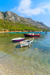 Fototapeta na wymiar Traditional fishing boats in sea bay on secluded beach, Samos island, Greece