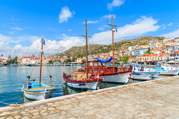 Row of traditional colourful Greek fishing boats in Pythagorion port, Samos island, Greece