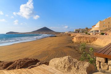 Fototapeta na wymiar A view of beautiful sandy El Medano beach in early morning sunlight, Tenerife, Canary Islands, Spain