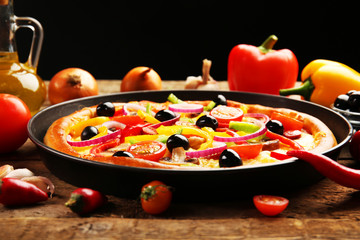 Delicious pizza with vegetables, on wooden table, close-up