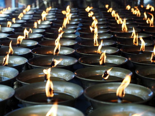 Burning lit candles at Chinese temple