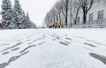 footprints on the snow in a winter city