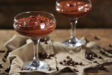 Chocolate dessert in glasses on wooden background