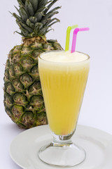 Pineaple juice with fresh pineapple isolated on white. Peru.