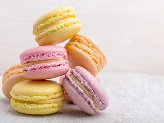 Colorful macarons on vintage pastel background