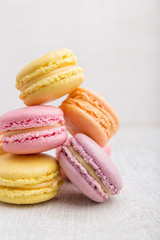 Colorful macarons on vintage pastel background