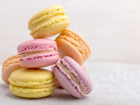 Colorful macarons on vintage pastel background