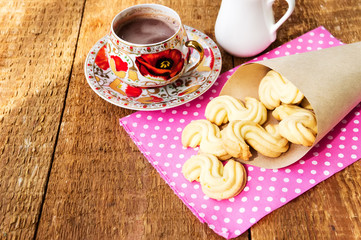 Homemade cookies with cup of hot chocolate on wooden table