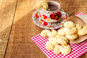 Homemade cookies with cup of hot chocolate on wooden table