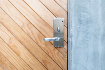 Closeup brown wooden door with handle background