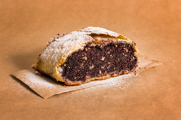 Slice of fresh baked homemade strudel with poppy seeds and sugar