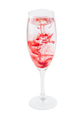 Full wineglass with red stains isolated on a white background