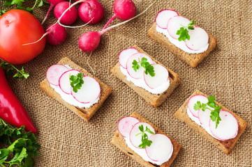 Spring sandwiches with ingredients on sackcloth background