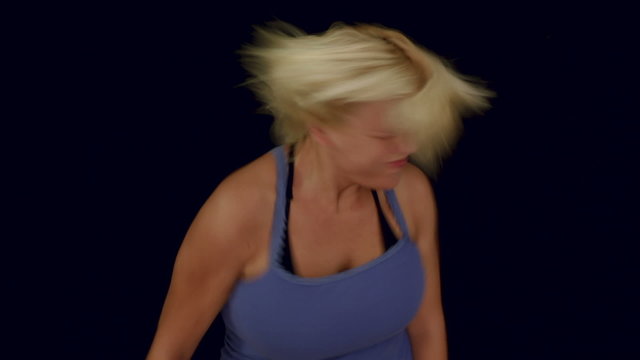 Blond woman with sunhat enjoying music and dancing, studio isolated.