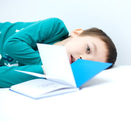 Little boy is reading a book