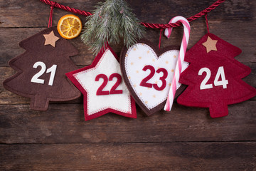 Advent calendar with fir and candy cane on an old wooden background.