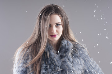 sensual girl in a coat over gray background.