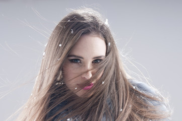 sensual girl in a coat over gray background.