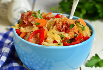 Cabbage stewed with chicken meatballs in tomato sauce.